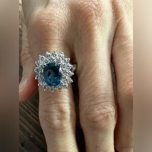 Oval sapphire stone ring with pave halo